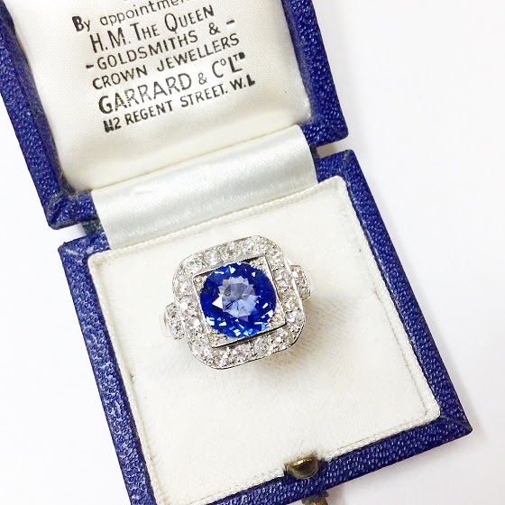 A blue diamond ring placed in its case