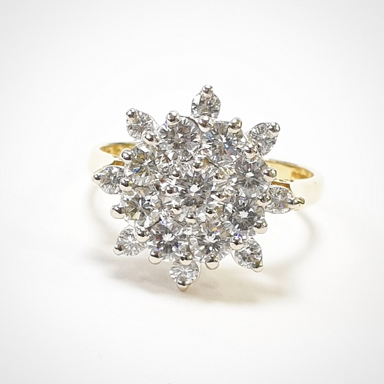 A gold ring with a large diamond star design