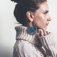 woman_wearing_pullover_with_large_earrings.jpg
